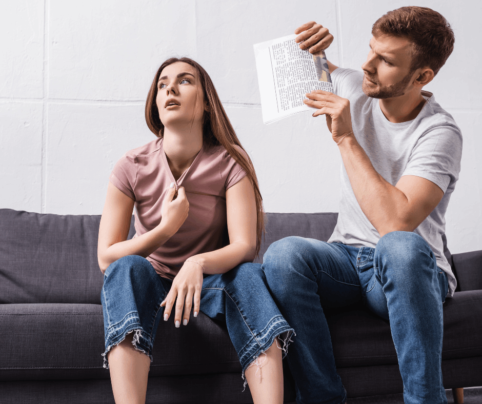 A man and a woman sweating while sitting on their couch