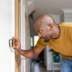 homeowner checking thermostat