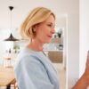homeowner adjusting thermostat